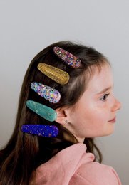  Oval resin hair clips in various glitter and sprinkle designs, including mermaid, butterfly, and more. Suitable for kids.