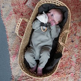 A cozy, sage green newborn jumpsuit with a ribbed texture, suitable for babies aged 0-12 months.