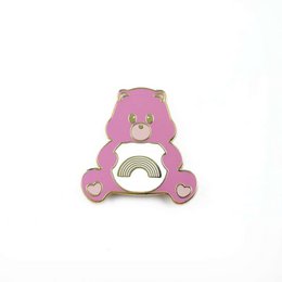A pink and white Care Bear brooch with a rainbow design. The brooch features the iconic Care Bear design with a rainbow motif, making it a whimsical and colorful accessory.