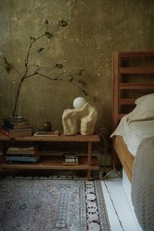 A handmade, matte gray vase with a simple, cylindrical shape.