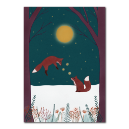 A whimsical A5 print featuring two playful foxes in a snowy forest scene under a bright moon. The image showcases a vibrant, artistic style with a focus on the foxes' playful interaction and the serene winter landscape.