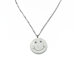 Silver-toned smiley face charm pendant on a delicate chain necklace.