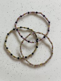 Sparkling beaded bracelets in shades of brown, gold, and purple. Featuring a faceted design with a mix of bead shapes and sizes for a stylish, textured look.