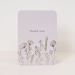 A simple thank you card with a floral design and a heart icon. The card has a light pink background and the text "Thank you" is printed in a minimalist style.