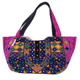 Handmade antique deep cerise tote bag with vibrant, patterned design featuring bold colors, geometric shapes, and intricate embroidery. Suitable for shoulder wear.