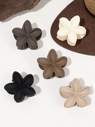  Elegant floral hair clips in neutral colors including black, white, beige, and gray. Flower-shaped accessories with a simple, minimalist design.