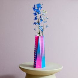 Large papaya-colored vase with abstract geometric patterns in various colors including pink, green, and orange.