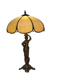 A medium-sized Tiffany-style table lamp with a figure base and a 30cm diameter shade in the Virginia Series.