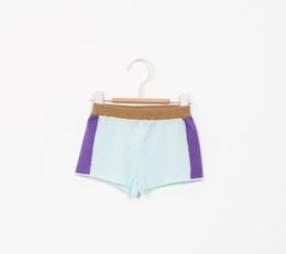 Colorblock kids' shorts in a retro style. Made of lightweight, breathable fabric in a mint green and purple color palette. Features a relaxed, comfortable fit for active play.