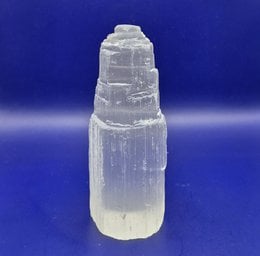  Tall, cylindrical selenite crystal tower measuring 10x5cm. Selenite is a type of gypsum mineral known for its translucent, white appearance and natural, layered structure.