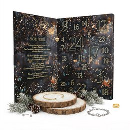  A black advent calendar with gold and colorful glitter accents, featuring numbered compartments for each day leading up to Christmas. The calendar has a wooden stand and appears to be designed for holding small jewelry or trinket items.