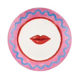 Round dessert plate with pink and blue wavy pattern and red lips graphic.