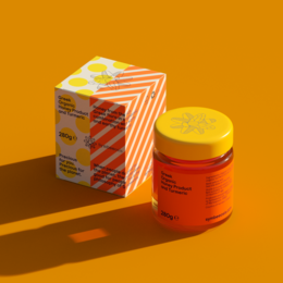 Greek organic honey with turmeric, natural ingredients, vibrant orange packaging.
