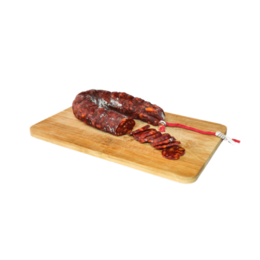  Spicy, cured sausage with a reddish-brown color, sliced on a wooden cutting board.