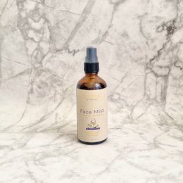  Lavender-infused face mist in a glass bottle with a spray nozzle. Soothing and hydrating for the skin.