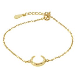 Gold-toned crescent moon charm bracelet with delicate chain.