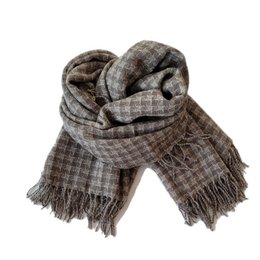 Warm, plaid-patterned shawl with fringe edges, suitable for cold weather and casual outfits.