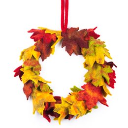 Autumnal fair trade felt wreath with vibrant red, yellow, and orange maple leaves.