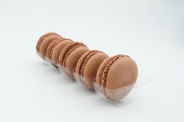 Round, brown macarons with a smooth, glossy surface and a delicate, airy texture. Made with chocolate flavoring.