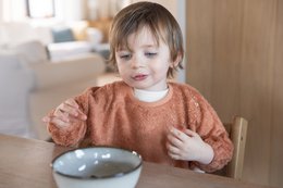 Bib with long sleeves in a variety of soft pastel colors including misty rose, rosewood, apricot blush, aspen green, marin, honey yellow, moon blue, feather grey, frosted almond, mellow mauve, whisper green, daisy white, silky lilac, savannah sand, jungle green, and riviera blue.