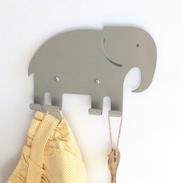 Gray elephant-shaped wall hook for hanging kids' clothing and accessories. Made of durable material with a simple, modern design.