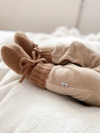 Cozy brown merino wool bootie slippers for babies, featuring a soft knit texture and a decorative bow detail.