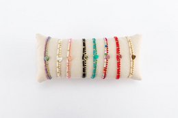  16 assorted charm bracelets on a roll, featuring colorful beads and charms in various styles.