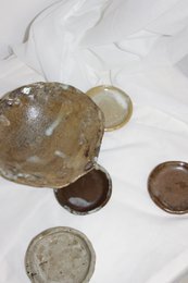 Large, handmade decorative bowl with a unique, textured surface and a neutral color palette.