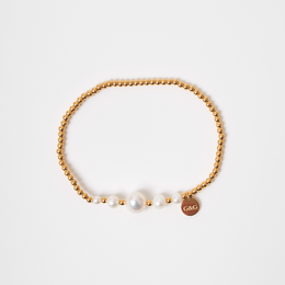 Gold and silver beaded bracelets with pearl accents. Delicate and elegant jewelry pieces.