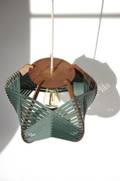 Large dark green pendant lamp with textured glass shade and wooden accents. Suitable for ceiling installation or tabletop use.