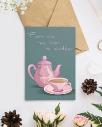 A pink teapot and cup on a teal background with the text "From one tea lover to another" written on the image.
