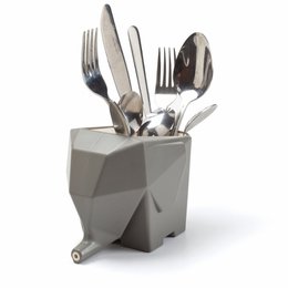 A modern, geometric gray utensil holder containing various kitchen utensils such as forks, knives, and spoons. The holder has a unique, angular design that adds a stylish touch to any kitchen counter.