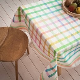 A colorful, checkered tablecloth in shades of green, yellow, and white. The tablecloth appears to be made of a lightweight, woven material and is suitable for use on a table or other surface.