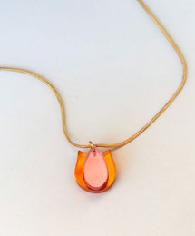  Gold chain necklace with orange tulip flower pendant, delicate curved design.