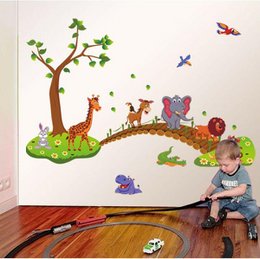 Colorful wall stickers featuring a whimsical savannah scene with a wooden bridge, animals like giraffes, elephants, and lions, and butterflies. Suitable for decorating a nursery or child's room.