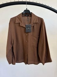 "Women's long sleeve button-up blouse, available in multiple colors including brown, beige, taupe, blue, black, and green."