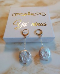 White and gold stud earrings with large baroque pearl drops.