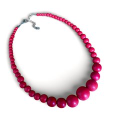  Beaded necklace with round gemstone spheres, available in vibrant pink and blue colors, adjustable chain closure.