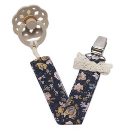Pacifier holder BOHO FLOPI Navy, a stylish and functional accessory for parents. The pacifier holder features a navy blue floral pattern with a boho-inspired design, making it a practical and fashionable choice for keeping pacifiers close at hand.