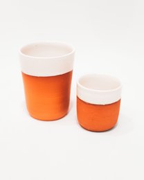 Set of 2 white glazed terracotta cups in orange color. Suitable for use as plant pots or decorative containers.