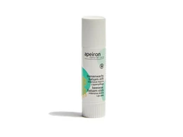  Beeswax balm pen in a cylindrical white container with green and yellow accents. Contains natural ingredients for lip care.