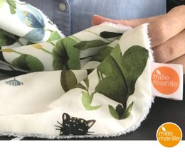 Soft, absorbent burp cloth with a whimsical garden-inspired print featuring leaves, flowers, and butterflies. Made of high-quality cotton for gentle use on baby's skin.