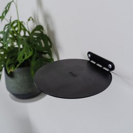 Minimalist, floating, invisible black steel wall/room shelf for plants, ornaments, or books. Round shape, 16cm diameter.
