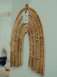 Rattan rainbow wall accessories, a decorative garland for kids' rooms, featuring a woven arch shape in natural tones.