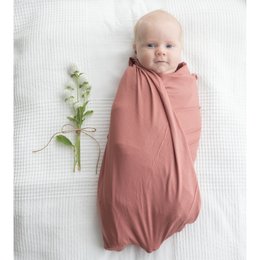 Soft, cozy swaddle cloth in a warm salmon color, perfect for snuggling and comforting newborns.