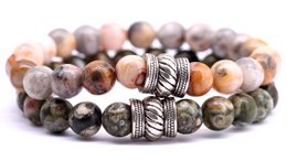 Beaded bracelet set with agate and rhyolite stones in medium and large sizes. Features natural stone beads in earthy tones and metallic accents.