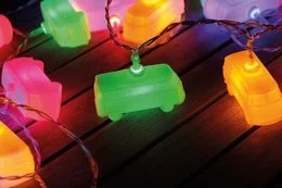 Colorful 3D string lights in the shape of classic Volkswagen VW T1 buses, creating a festive and nostalgic atmosphere. The lights come in a variety of vibrant colors including green, orange, and red.