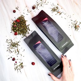Enchanted by Love Refill 75 grams, a fragrant tea blend with a mix of dried flowers, herbs, and berries, packaged in a sleek black box.