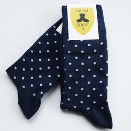 Navy blue socks with white polka dots, suitable for casual or formal wear.