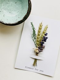 Dried lavender and wildflower bouquet in a rustic vase. Soft, natural colors and textures.